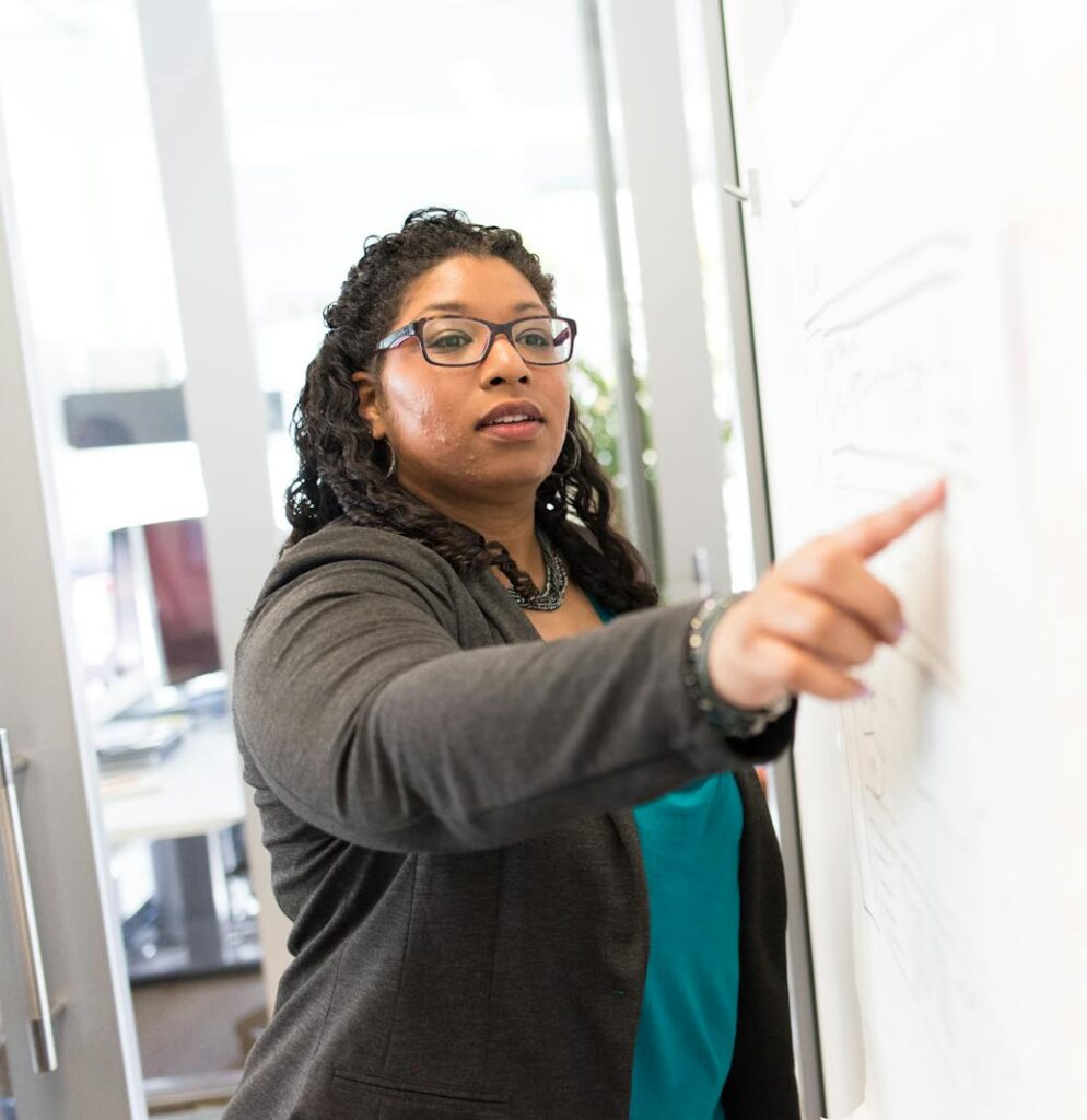 Confident businesswoman making a point during a presentation in an office setting.